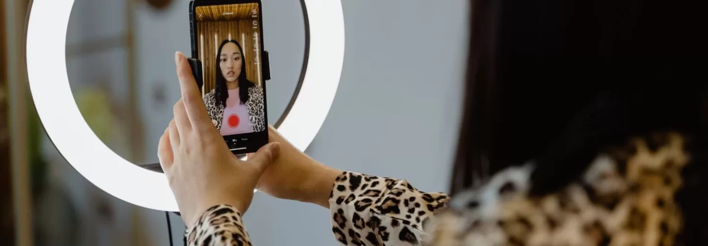 person taking selfie with ringlight