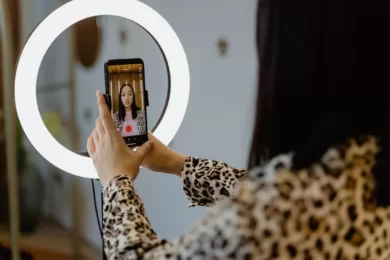 person taking selfie with ringlight