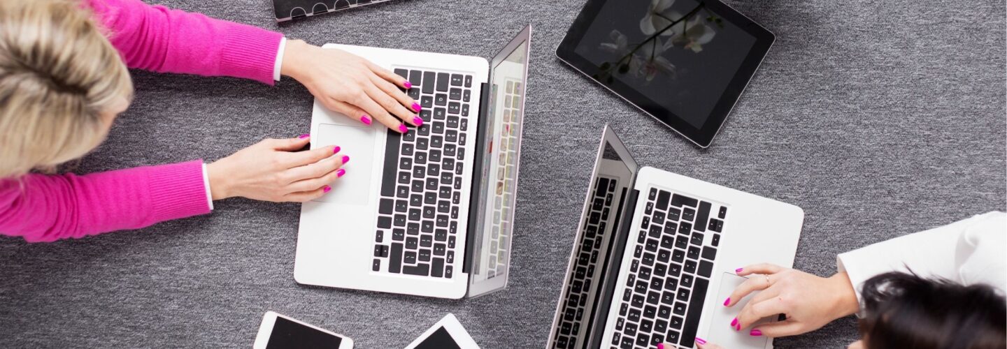 top view of two individuals working on their laptops