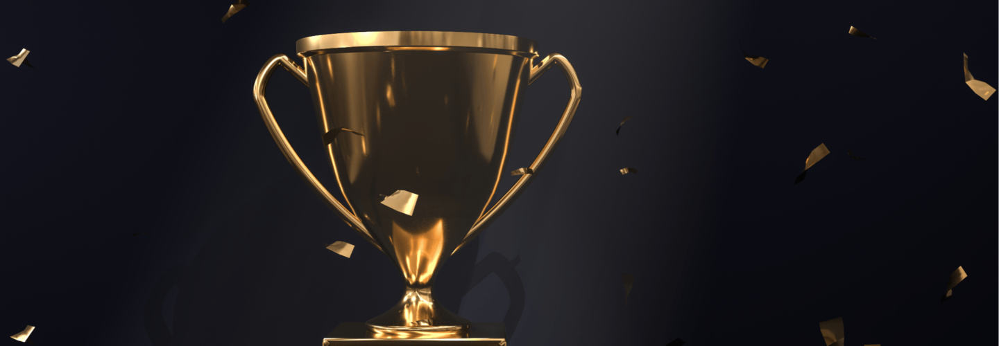 golden trophy on a black background with confetti